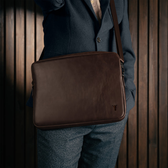 Man carrying the Dark Brown Leather Messenger Bag