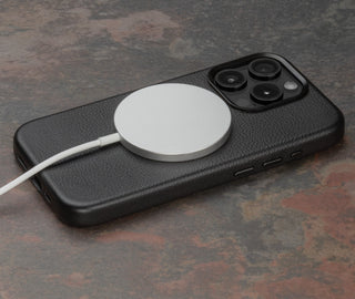 MagSafe charger attached to the Black Slimline Leather Bumper Case for iPhone 15 Pro