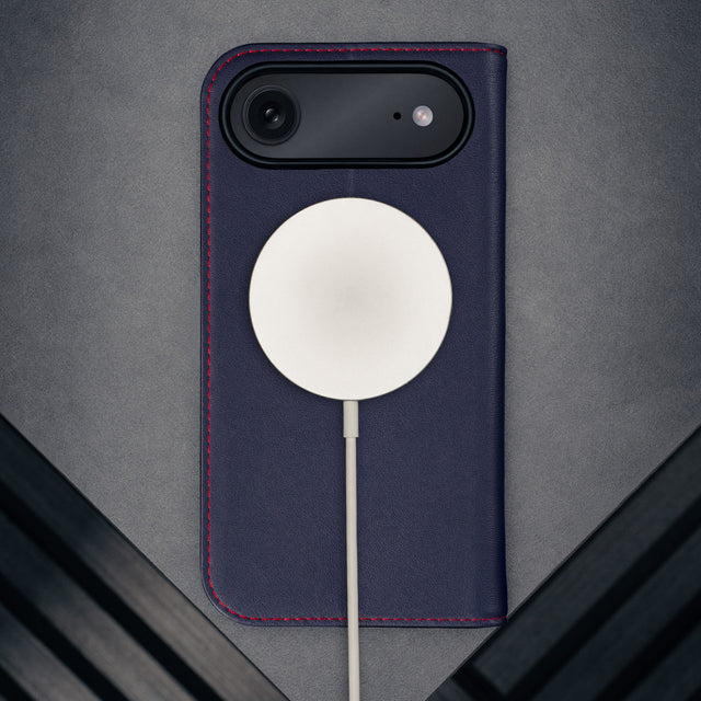 MagSafe charger attached to the Navy Blue Leather Case for iPhone 17 Air