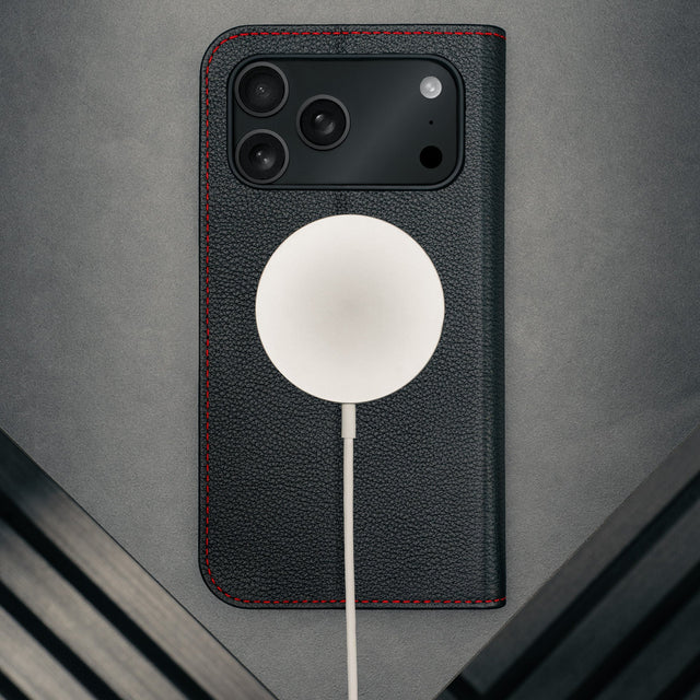 MagSafe charger attached to the Black Leather Case (with Red Stitching) for iPhone 17 Pro Max